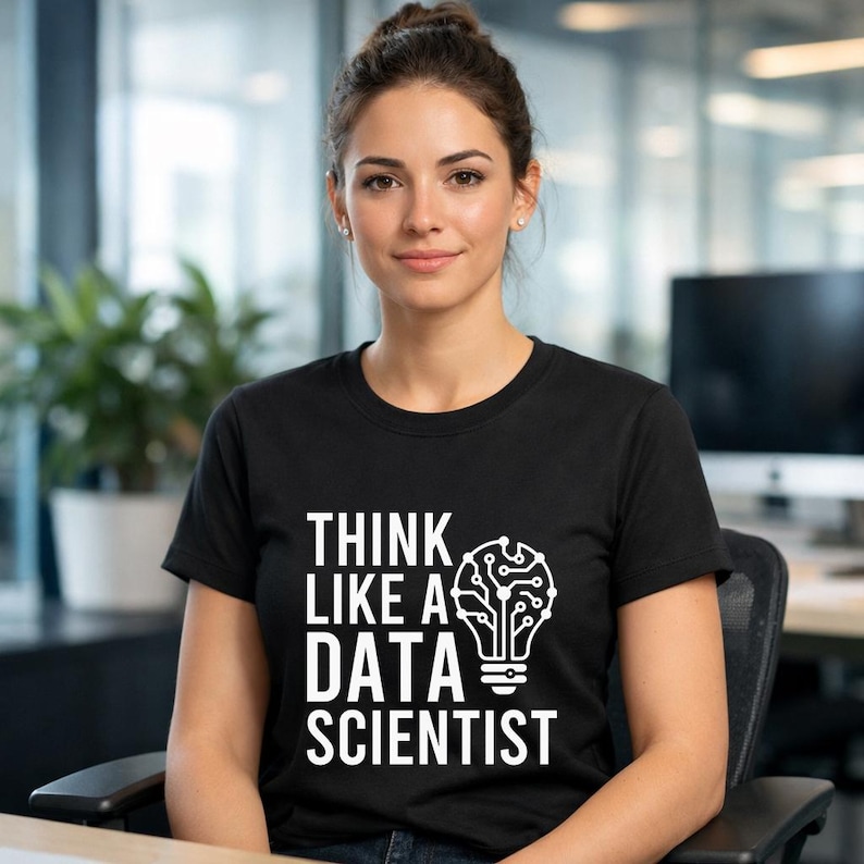 May include: Black crew neck t-shirt with the text "THINK LIKE A DATA SCIENTIST" in white. The design includes a lightbulb graphic with a brain-like pattern inside. The person in the image is wearing the shirt.