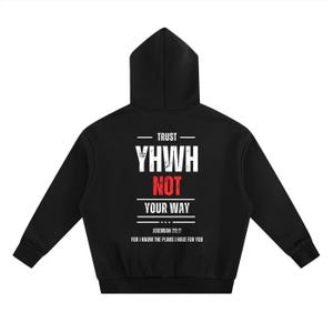 May include: Black hoodie with white text that reads "TRUST YHWH NOT YOUR WAY" and the Bible verse Jeremiah 29:11. The hoodie has a hood and long sleeves. The text is centered on the back of the hoodie.