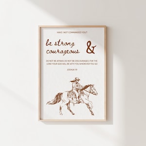 May include: A framed wall art print featuring a white background with brown text that reads: HAVE I NOT COMMANDED YOU? be strong & courageous DO NOT BE AFRAID; DO NOT BE DISCOURAGED, FOR THE LORD YOUR GOD WILL BE WITH YOU WHEREVER YOU GO JOSHUA 1:9.
