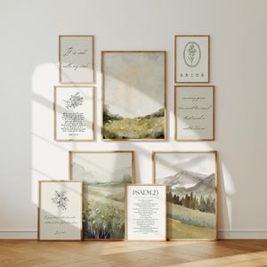 May include: A collection of framed art prints with inspirational quotes and landscape paintings. The prints feature botanical illustrations, watercolor landscapes, and text including "It is well with my soul" and "Psalm 23". The frames are a warm, natural wood tone.