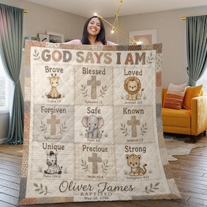 May include: A quilted blanket featuring the text GOD SAYS I AM and nine grid squares with illustrations of a giraffe, lion, elephant, zebra, and leopard, alongside crosses and Bible verses. The bottom includes the name Oliver James, Baptized, May 12, 2026.