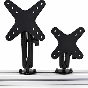 May include: Two black metal monitor mounts with X-shaped VESA plates attached to a silver aluminum rail. Each mount features a central adjustable arm with a ball joint mechanism and a tightening knob, allowing for flexible positioning of the display.
