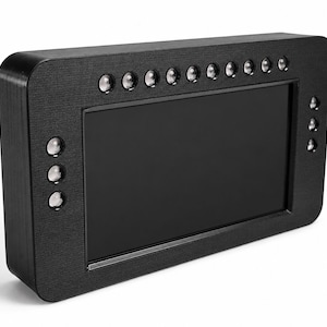 May include: A black rectangular electronic device with a screen. The device has a textured surface and several small, round buttons along the top and side. The screen is black and appears to be off. A black cable extends from the back of the device.