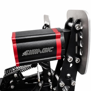 May include: A black and red Simagic racing pedal assembly featuring a metallic silver pedal face, a cylindrical housing with the white Simagic logo, exposed metal springs, and black structural support brackets secured with visible steel bolts.