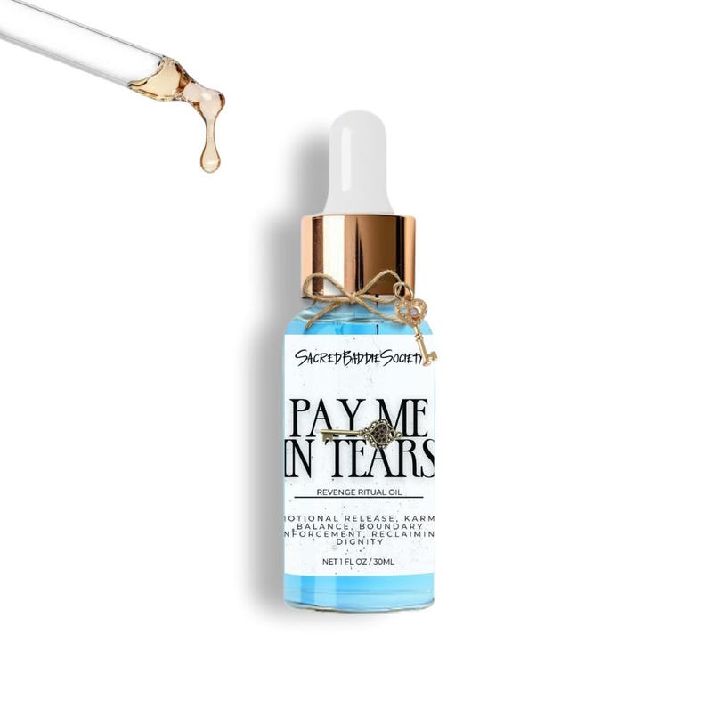 May include: A blue glass bottle with a gold cap and a white dropper. The bottle has a label with the text "PAY ME IN TEARS" and "REVENGE RITUAL OIL". A small key charm is tied around the neck of the bottle. The bottle contains 1 fl oz / 30ml of liquid.