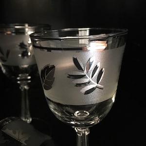 Vintage Libbey Frosted Silver Leaf pattern Wine Glasses.  Classy Glassware dating 1953 to 1978.  Even the stems are stunning with their cut design.  Set of 5.  Not quite 6 inches high and hold almost 5 fluid ounces each.  Very good vintage condition.