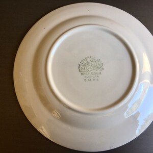 May include: White ceramic plate with a green "Eggshell Gearhart" logo on the bottom. The logo includes the words "Homer Laughlin China Co.  U.S.A." and "E 41 H 5".