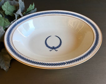 May include: White oval serving bowl with a blue and gold laurel wreath design around the rim.