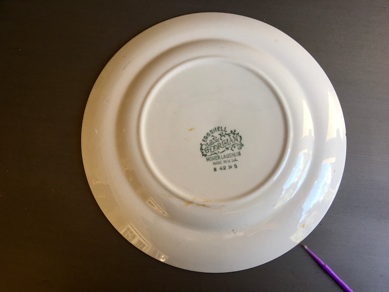 May include: White ceramic plate with a green and white logo that reads "Eggshell Georgian Homer Laughlin Made in U.S.A. # 42 N 5"