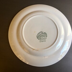 May include: White ceramic plate with a green "Eggshell Georgian" logo and the text "Homer Laughlin Made in U.S.A. B 42 N 5".