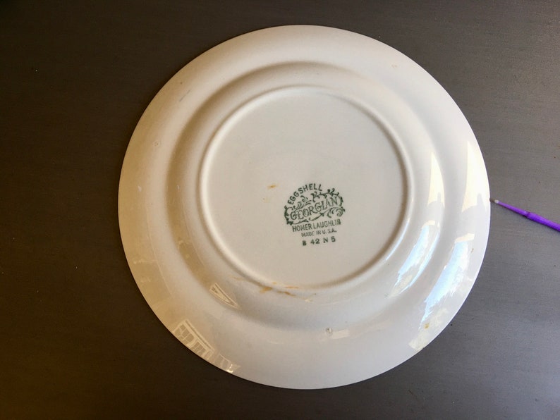 May include: White ceramic plate with a green "Eggshell Georgian" logo and the text "Homer Laughlin Made in U.S.A. B 42 N 5".