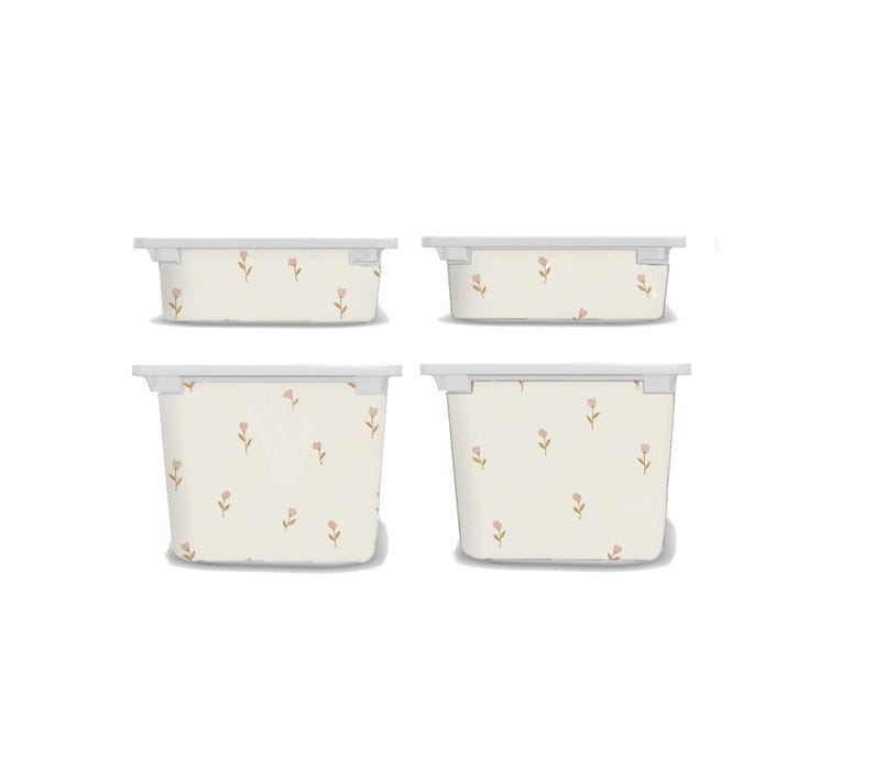 May include: Four off-white storage bins with lids, each adorned with a delicate floral pattern in soft pink. The bins vary in size, offering versatile storage solutions. The design is simple and elegant, suitable for various home decor styles.