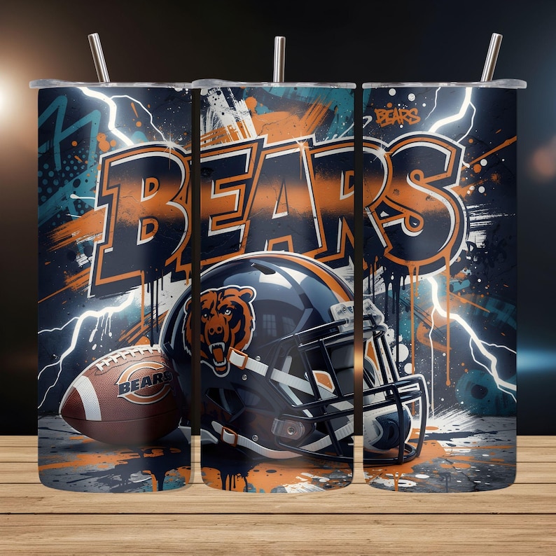 May include: A stainless steel tumbler featuring a Chicago Bears football theme. The design includes a football, helmet, and the word "BEARS" in orange and navy blue, with lightning bolt accents. The tumbler has a straw.