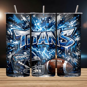 May include: A tumbler featuring a blue and white design with the word "TITANS" in a graffiti style. The design includes a football helmet and a football. The background has a blue splatter and lightning bolt effect.