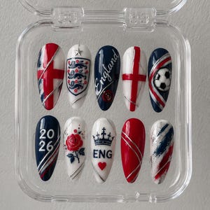May include: A set of ten almond-shaped press-on nails in a clear plastic case. The designs feature the England flag, the Three Lions crest, a soccer ball, a red rose, a crown, the text 2026 and ENG, and red, white, and blue color schemes.