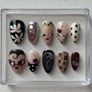 May include: A trio of ceramic mugs with a speckled, matte finish in cream, light grey, and dark grey. Each mug features a simple, minimalist design, ideal for tea or coffee.