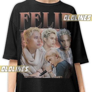 Puede incluir: Camiseta negra con un gráfico de cuatro personas con cabello rubio. La palabra "FELIP" está impresa en letras grandes y desgastadas en la parte superior. El texto "OLDLINES" está impreso en una pancarta en el lado derecho.