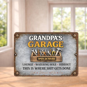 May include: A rectangular metal sign with the words "GRANDPA'S GARAGE" in yellow and white. The sign features a toolbox graphic with various tools and the text "OPEN 24 HOURS". Additional text includes "LOUNGE WATERING HOLE HIDEOUT THIS IS WHERE SHIT GETS DONE".