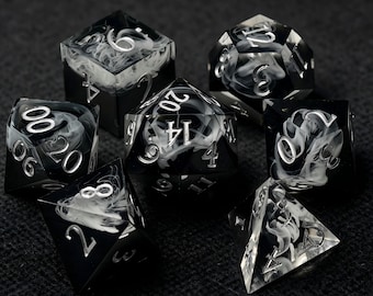 May include: A set of seven polyhedral dice made of translucent black resin with swirling white smoke-like patterns inside. Each die features sharp edges and deeply engraved numbers painted in a metallic silver finish for high visibility and contrast.