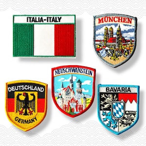 May include: A collection of embroidered patches featuring various European locations. Includes patches with the Italian flag and the text "ITALIA-ITALY", a shield-shaped patch with "MUNCHEN", and others with "DEUTSCHLAND", "NEUSCHWANSTEIN", and "BAYERN".