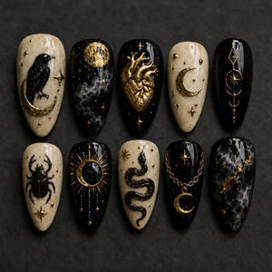 May include: A set of ten artificial nails with a dark, gothic theme. Each nail features unique designs, including a raven, moon, heart, stars, and a snake, all in gold and black. The nails have a glossy finish.