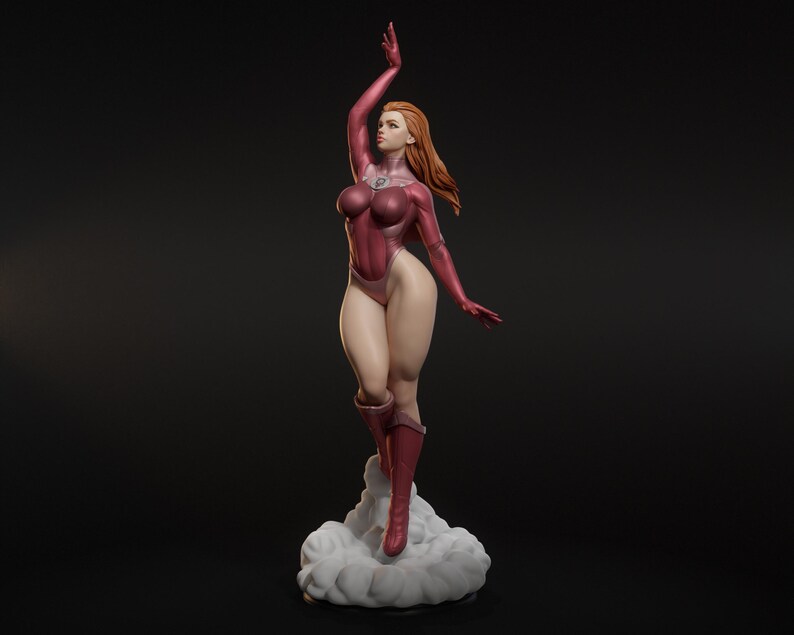 May include: A figurine of a woman in a dynamic pose, clad in a maroon bodysuit and boots. Her red hair flows, and she stands atop a cloud-like base. The figure has a determined expression, with one arm raised.