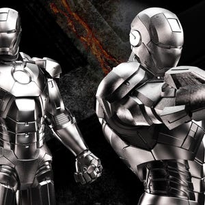 May include: Two metallic silver Iron Man suits are displayed against a dark background. The left figure stands upright, while the right figure is posed with an outstretched arm. The words "AVENGERS ASSEMBLE" are in the top left corner.