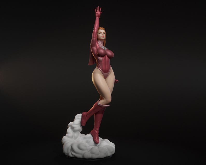 May include: A red-toned figurine of a woman in a superhero-style outfit, with a dynamic pose. She is wearing a form-fitting bodysuit, boots, and a cape. Her right arm is raised, and she is standing on a cloud-like base.