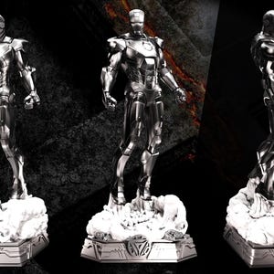 May include: A silver Iron Man statue in three views. The figure stands on a rocky base with the words "Avengers Assemble" at the top left. The statue is highly detailed and metallic, with a sleek, modern design.