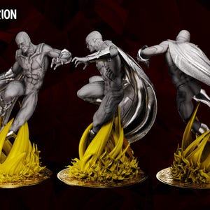 May include: A diorama featuring three Vision figures in dynamic poses, each atop a golden, flame-like base. The figures are grey and silver, with flowing capes. The text "WandaVision Diorama" and "Wicked" are visible.