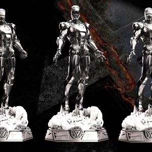 May include: Three metallic Iron Man statues on decorative bases. The statues are silver and stand on a cloud-like base. The bases have a geometric design. The text "AVENGERS ASSEMBLE" is in the upper left corner.