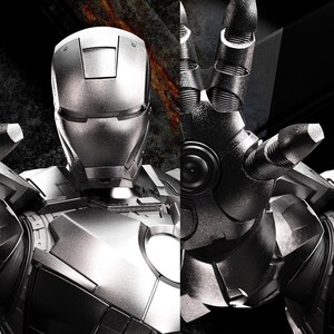 May include: A grayscale image of a metallic Iron Man suit, with the text "AVENGERS ASSEMBLE" in the upper left corner. The suit's hand is extended, and the face of the character is visible. The image has a dramatic, action-oriented feel.