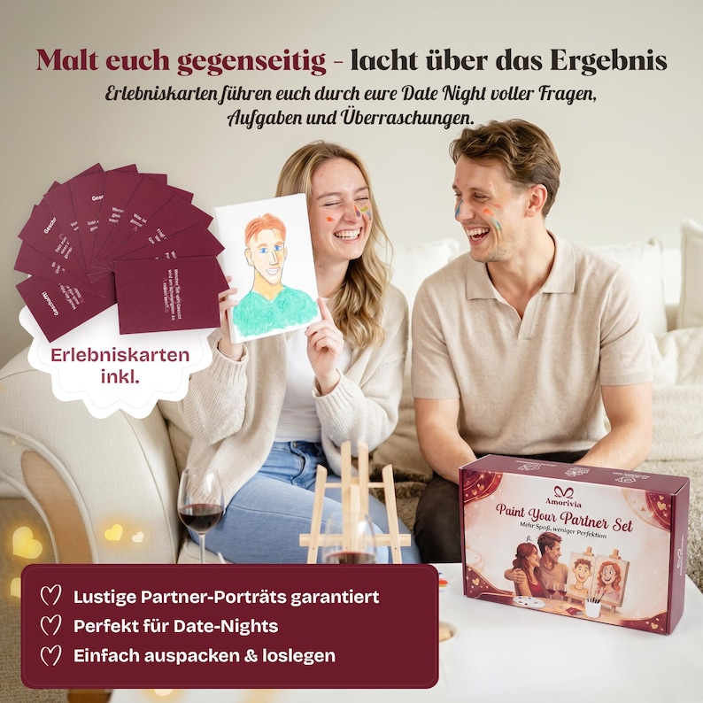 May include: A Paint Your Partner Set in a rectangular box with a burgundy and white design, featuring a set of burgundy cards with German text, a small wooden easel, and a hand-drawn portrait of a person with orange hair and a green shirt.