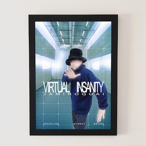 May include: Framed poster featuring the text "VIRTUAL INSANITY" and "JAMIROQUAI". The image shows a person in a blue jacket and black hat, set against a futuristic, grid-lined background. The words "TRAVELLING WITHOUT MOVING" are also present.