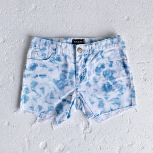 May include: Blue and white tie-dye denim shorts with frayed edges and a "CHAPS" label on the back waistband.