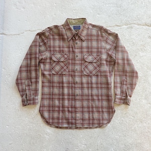 May include: A button-down plaid shirt in shades of red, tan, and white. The shirt has two chest pockets and a collared neckline. The long-sleeved shirt is made of a soft, woven fabric.