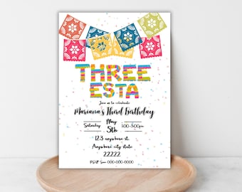 May include: A white invitation card with colorful text and decorations for a third birthday party. The card features the words "THREE ESTA" in bright colors, along with the party details, including the date, time, and location.