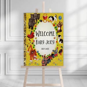 May include: A yellow welcome sign on an easel with the text "WELCOME BABY JOEY" and "JULY 20XX". The sign is decorated with illustrations of animals, including an elephant, dog, rabbit, and lion.