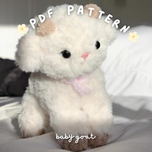 May include: A fluffy white baby goat toy with a pink bow. The soft toy has black eyes, a pink nose, and brown hooves. The image includes the text "PDF PATTERN" and "baby goat".