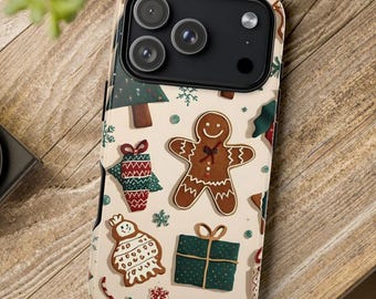 May include: A phone case with a festive Christmas design. The case features a beige background with gingerbread men, Christmas trees, presents, and snowflakes. The case has a black camera module.