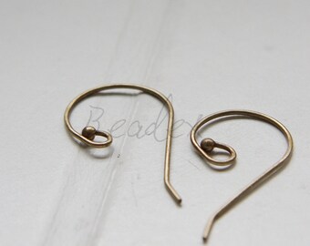 May include: Two gold-toned earring hooks with a small ball at the top of each hook.