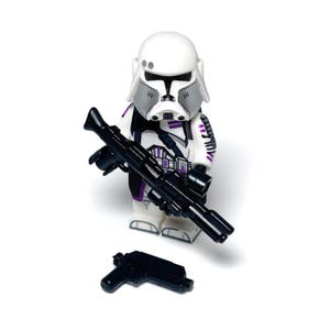 May include: A white and grey Stormtrooper Lego minifigure with purple detailing, holding a black blaster rifle and a smaller black pistol. The figure has a detailed helmet and armour design, standing on a white surface.