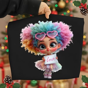 May include: Black tote bag featuring a cartoon girl with colorful hair, heart-shaped sunglasses, and a tutu. The girl holds a sign that says "love". The image has a festive background with Christmas decorations.