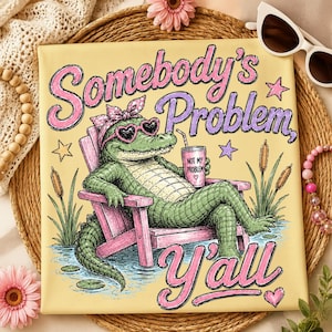 May include: A yellow canvas print featuring a cartoon alligator wearing heart-shaped sunglasses and a bow, relaxing in a pink chair with a drink. Text reads "Somebody's Problem, Y'all" with "Not My Problem" on the drink.