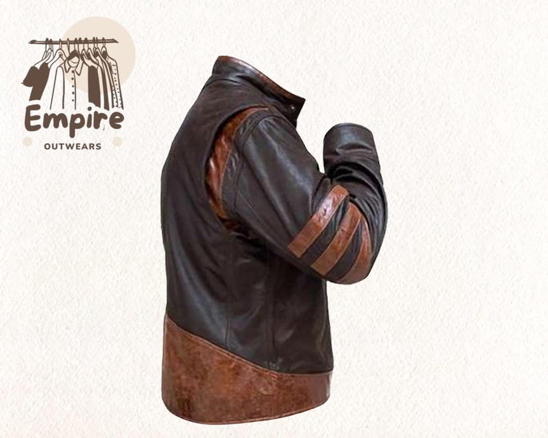 May include: A brown leather jacket with tan accents. The jacket features a stand-up collar, shoulder panels, and three tan stripes on the sleeves. The jacket has a two-tone design and is from Empire Outwears.