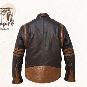 May include: A brown leather jacket with tan stripes on the sleeves and shoulders. The jacket has a two-tone design, with a darker brown body and a lighter brown lower section. The sleeves have zippers at the cuffs.