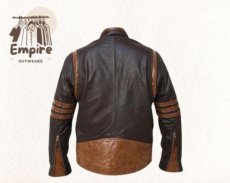 May include: A brown leather jacket with tan stripes on the sleeves and shoulders. The jacket has a two-tone design, with a darker brown body and a lighter brown lower section. The sleeves have zippers at the cuffs.