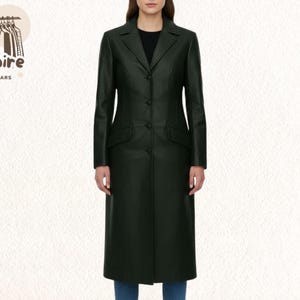 May include: A long, dark green leather coat with a classic button-down design. The coat features a notched collar, two front pockets, and a tailored fit. The model is wearing blue jeans. The Empire Outwears logo is in the top left corner.