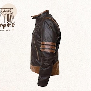 May include: A brown leather jacket with a stand-up collar and brown stripes on the sleeves. The jacket has a two-tone design, with a lighter brown at the bottom. The Empire Outwears logo is in the upper left corner.