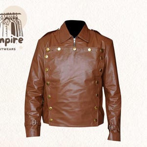 May include: Brown leather jacket with a black collar, gold buttons, and a zipper closure. The jacket has a classic design with a tailored fit and buckle details on the sleeves. The "Empire Outwears" logo is in the upper left corner.